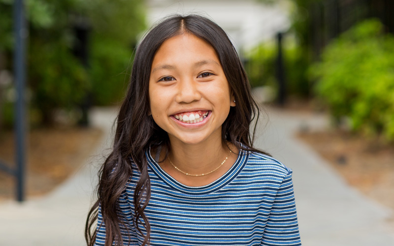 young girl smiling wide at the camera