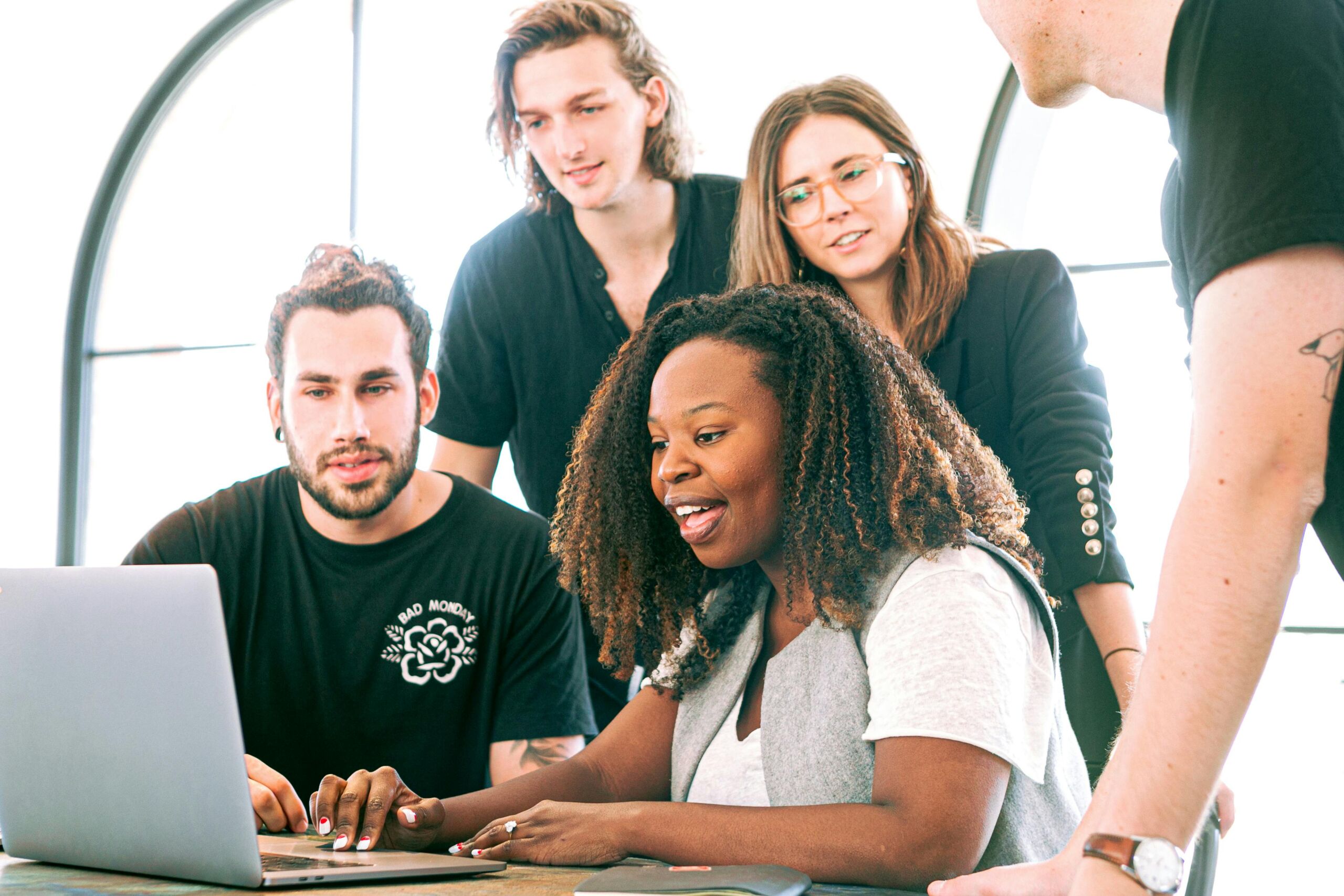 Employees gathered around a laptop